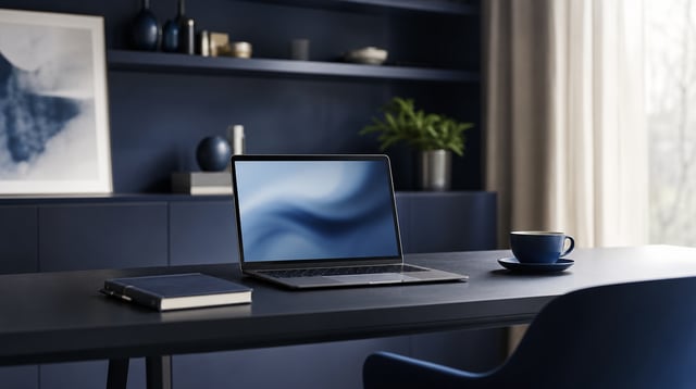 Minimal lender office desk with laptop, notebook, and coffee in soft blue light