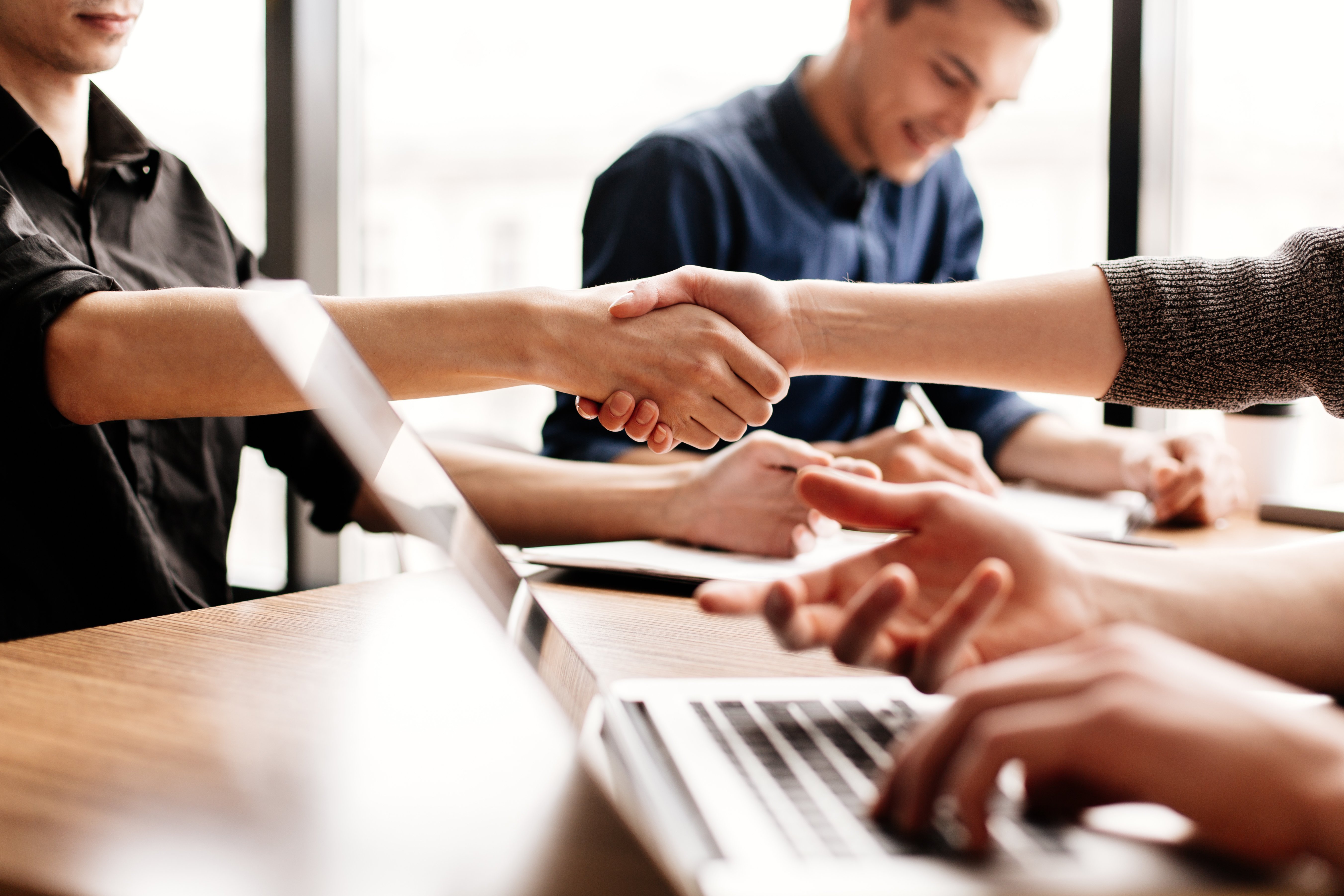 close-up-business-team-works-sitting-office-desk